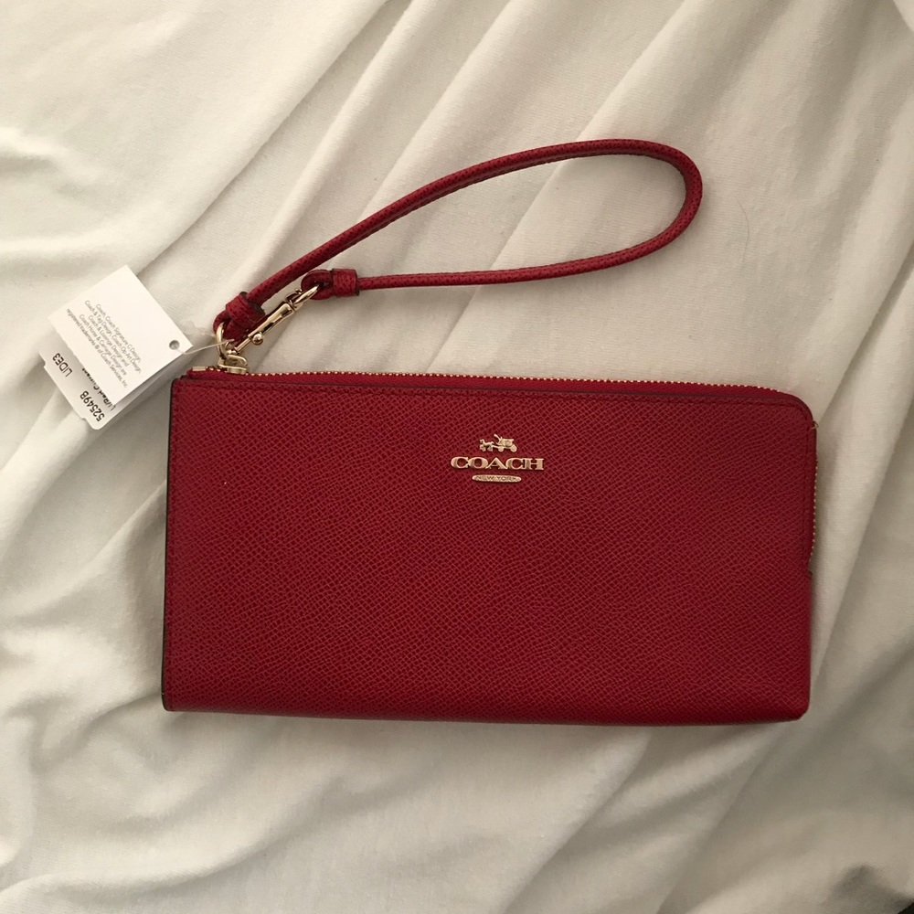 Brand new red Coach clutch, with tags.